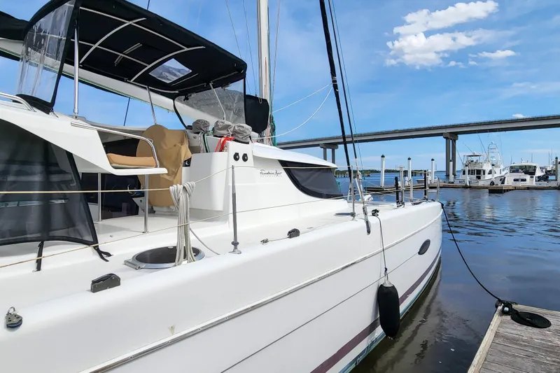 Slide: The Image of 2013 Fountaine Pajot Lipari 41 catamaran docked at marina under clear blue sky. - 8