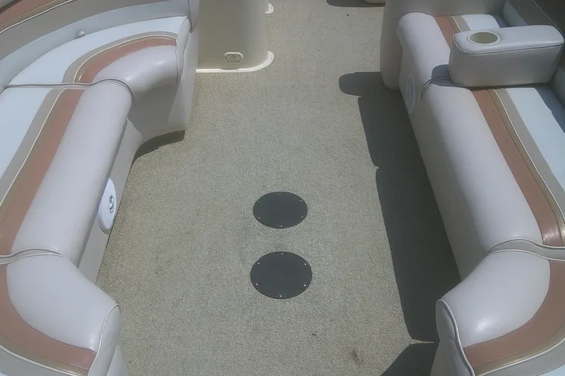 Slide: The Image of Interior of a 1999 Premier 250 Grand Majestic boat with beige seating and cup holders. - 10