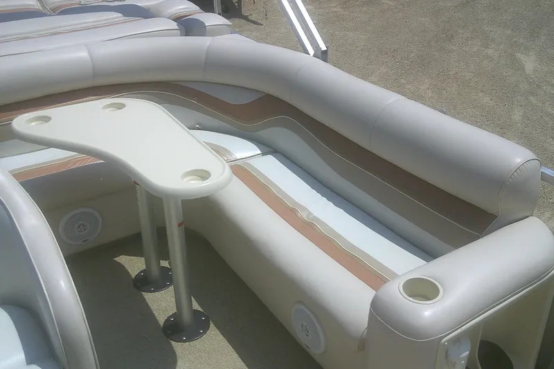 Slide: The Image of 1999 Premier 250 Grand Majestic boat interior with beige seating and table. - 12