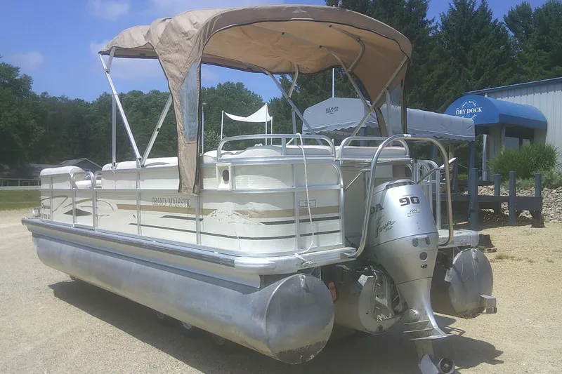 Slide: The Image of 1999 Premier 250 Grand Majestic pontoon boat with canopy and Honda outboard motor. - 2