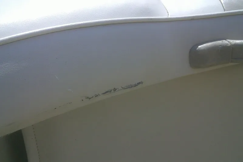 Slide: The Image of Damaged white upholstery on 1999 Premier 250 Grand Majestic boat seat. - 20