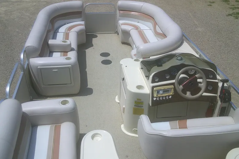 Slide: The Image of 1999 Premier 250 Grand Majestic pontoon boat interior with plush seating and control console. - 21