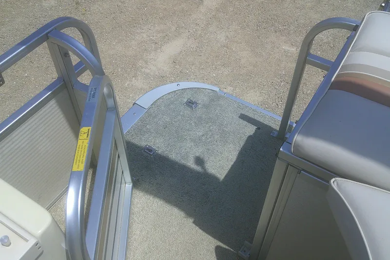 Slide: The Image of 1999 Premier 250 Grand Majestic pontoon boat interior with seating and entry gate. - 22