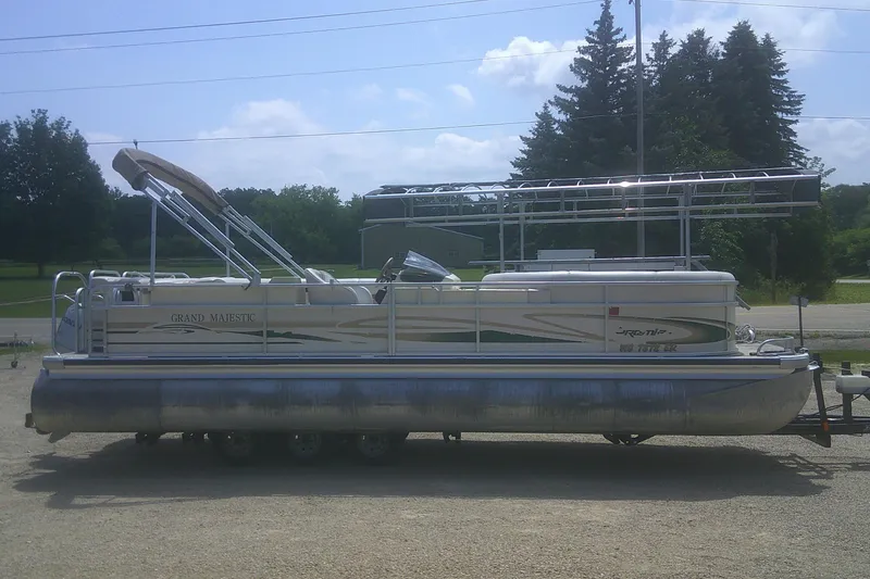 Slide: The Image of 1999 Premier 250 Grand Majestic pontoon boat on trailer, parked outdoors. - 25