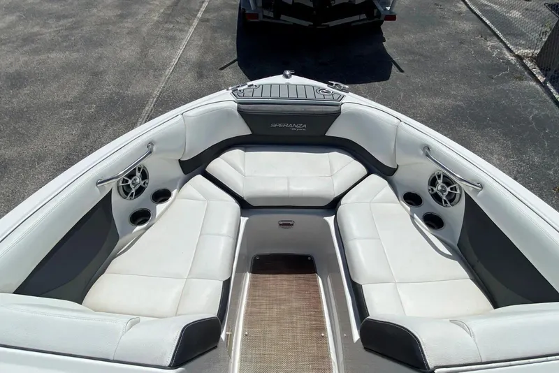 Slide: The Image of 2019 Bryant Speranza boat interior with white seating and built-in speakers. - 4