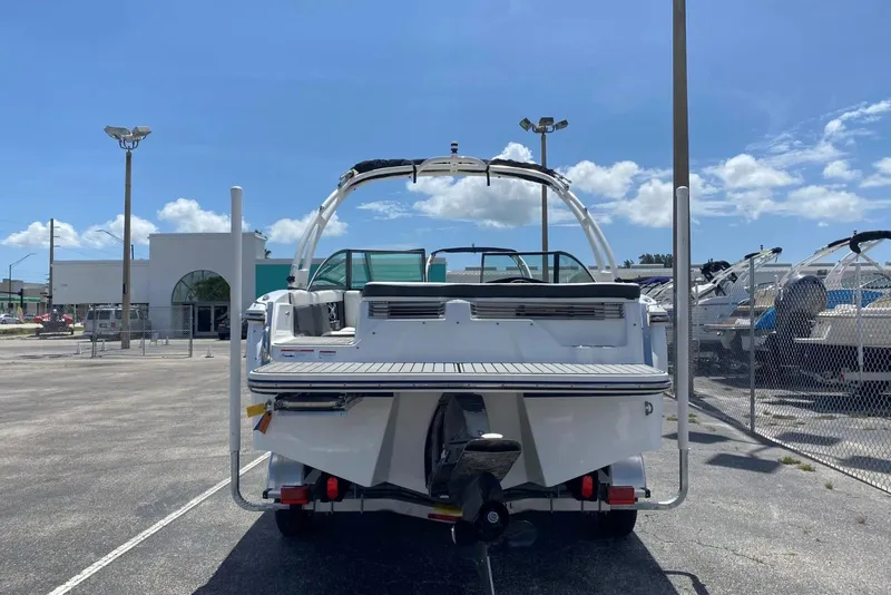 Slide: The Image of 2019 Bryant Speranza boat in a dealership lot under a clear blue sky. - 9