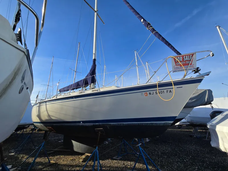 Slide: The Image of 1984 O'Day 30 sailboat for sale, docked on land, blue sky background. - 1