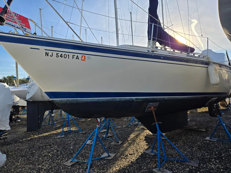 Slide: The Image of 1984 O'Day 30 sailboat on stands, NJ registration, in a boatyard. - 14