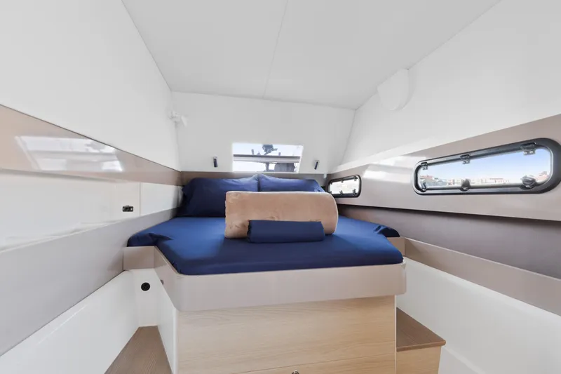 Slide: The Image of Luxurious cabin interior of 2018 Bali 4.0 yacht with blue bedding and porthole windows. - 20