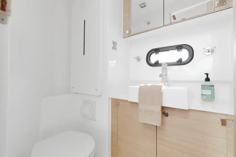 Slide: The Image of Modern bathroom interior on 2018 Bali 4.0 yacht, featuring sink, mirror, and porthole window. - 27