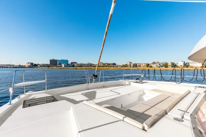 Slide: The Image of Deck view of 2018 Bali 4.0 catamaran with waterfront cityscape in background. - 31