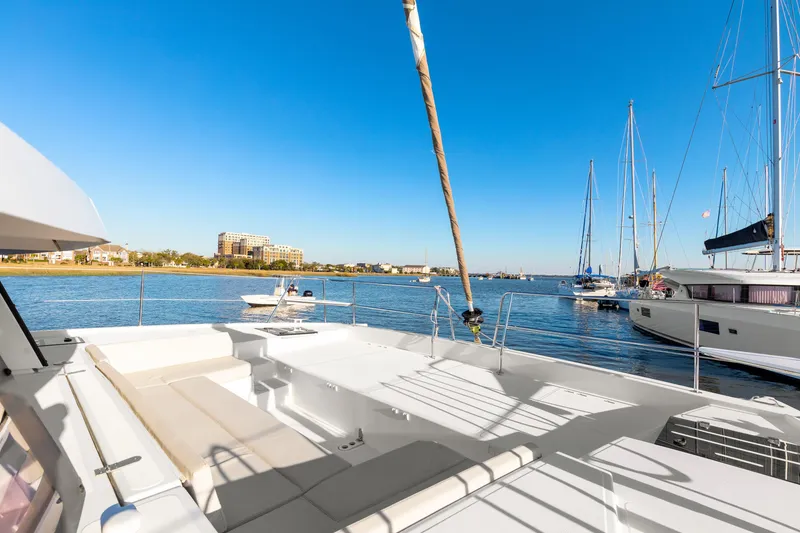 Slide: The Image of Luxurious 2018 Bali 4.0 catamaran docked in a scenic marina under clear blue skies. - 32