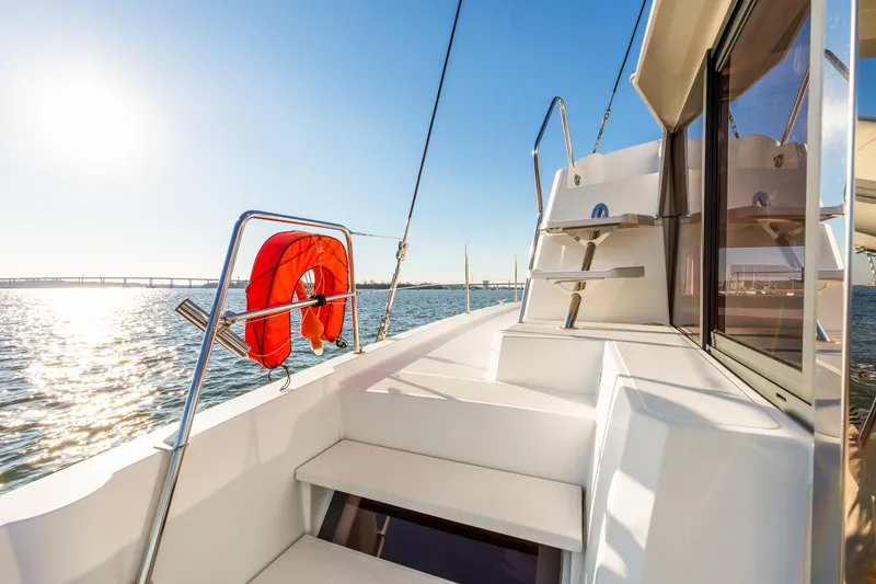 Slide: The Image of Bali 4.0 catamaran deck with lifebuoy, ocean view, and sunny sky, 2018 model. - 34