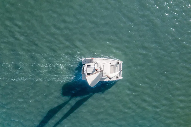 Slide: The Image of Aerial view of a 2018 Bali 4.0 catamaran sailing on clear turquoise water. - 44