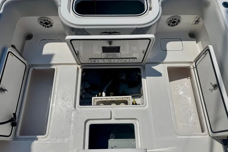 Slide: The Image of 2020 Invincible 36 Open Fisherman boat deck with open storage compartments. - 18