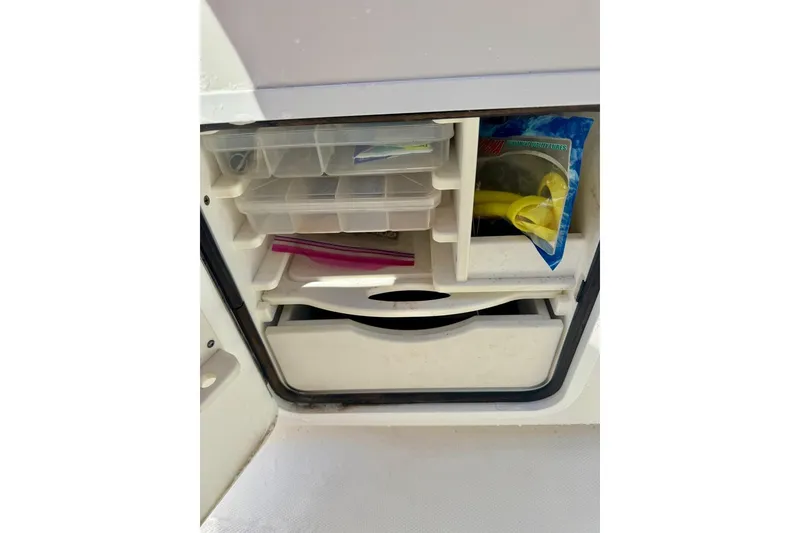 Slide: The Image of Storage compartment on 2020 Invincible 36 Open Fisherman boat with fishing gear and tackle boxes. - 23