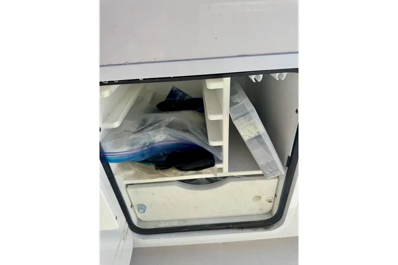 Slide: The Image of Storage compartment on a 2020 Invincible 36 Open Fisherman boat with organized gear. - 25