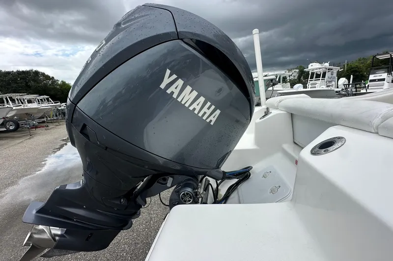 Slide: The Image of 2014 Tidewater 210 CC Adventure with Yamaha outboard motor under cloudy sky. - 11