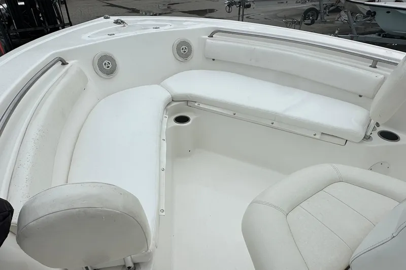 Slide: The Image of 2014 Tidewater 210 CC Adventure boat interior with white seating and cup holders. - 5