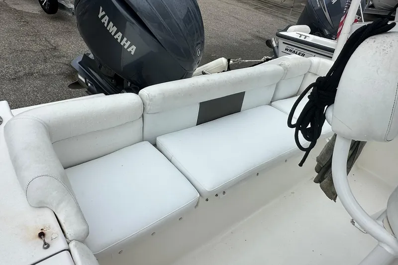 Slide: The Image of 2014 Tidewater 210 CC Adventure boat with Yamaha engine, featuring white cushioned seating. - 6