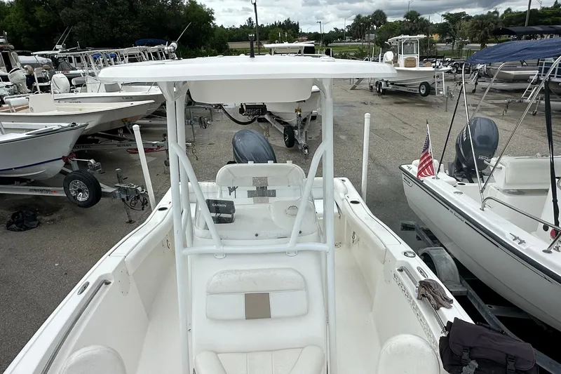 Slide: The Image of 2014 Tidewater 210 CC Adventure boat on trailer, surrounded by other boats in a marina. - 9