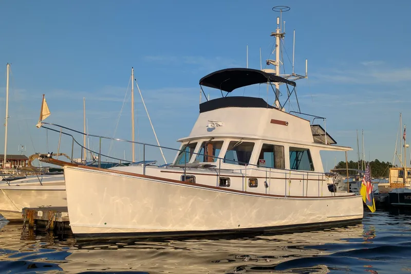 The Image of Duffy Flybridge 37 yacht, 2000 model, docked in a marina under clear blue skies. - 0