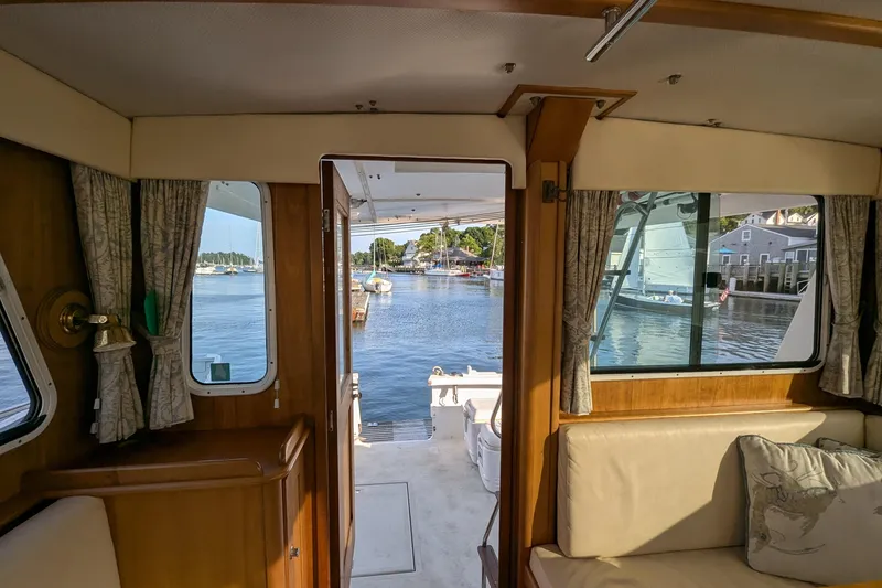 Slide: The Image of Interior view of 2000 Duffy Flybridge 37 yacht overlooking serene marina. - 10