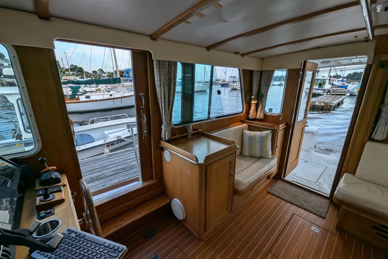 Slide: The Image of Interior of 2000 Duffy Flybridge 37 yacht with wooden decor and marina view. - 11