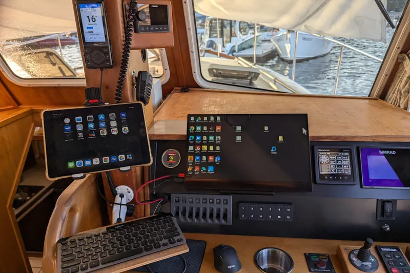 Slide: The Image of Control panel of a 2000 Duffy Flybridge 37 with modern navigation technology. - 17