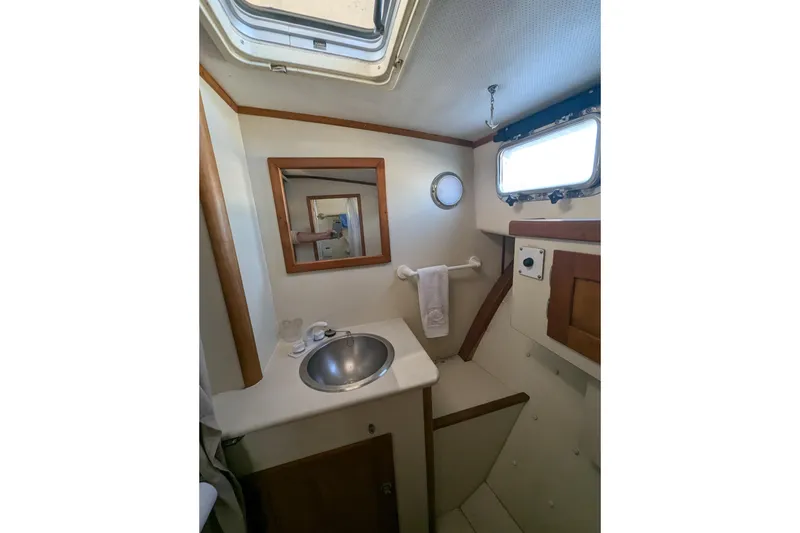 Slide: The Image of Bathroom interior of 2000 Duffy Flybridge 37 boat with sink and porthole window. - 19