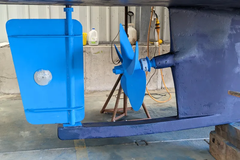 Slide: The Image of Propeller and rudder of 2000 Duffy Flybridge 37 boat in a workshop setting. - 24