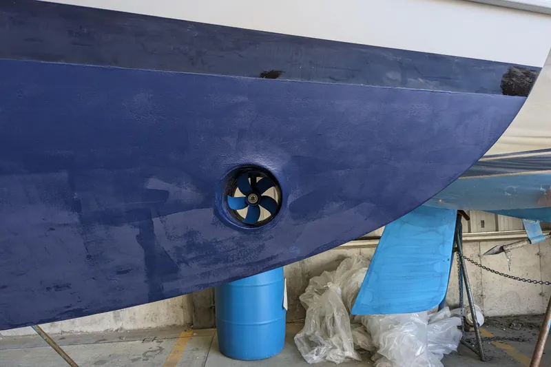 Slide: The Image of Close-up of a 2000 Duffy Flybridge 37 boat hull with a visible thruster. - 25