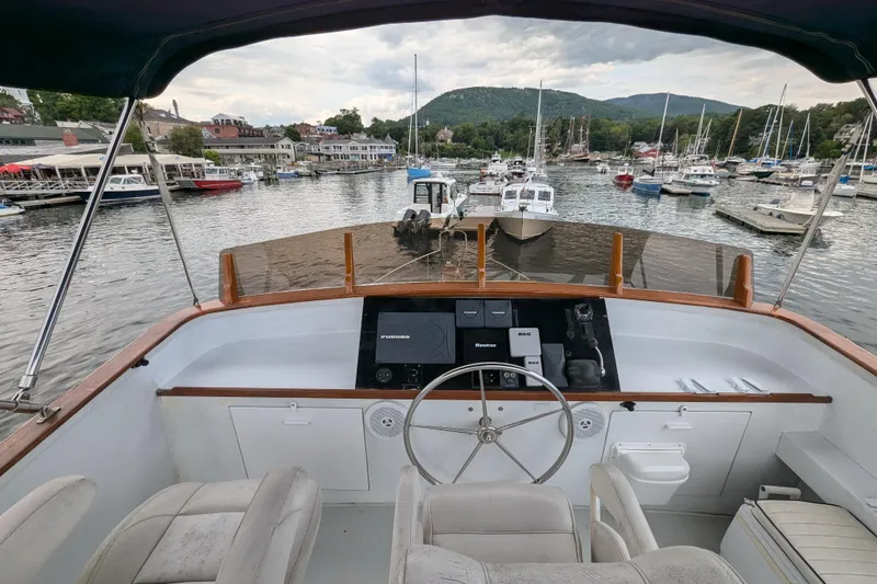 Slide: The Image of Flybridge view from 2000 Duffy Flybridge 37, overlooking a marina with boats and scenic hills. - 3