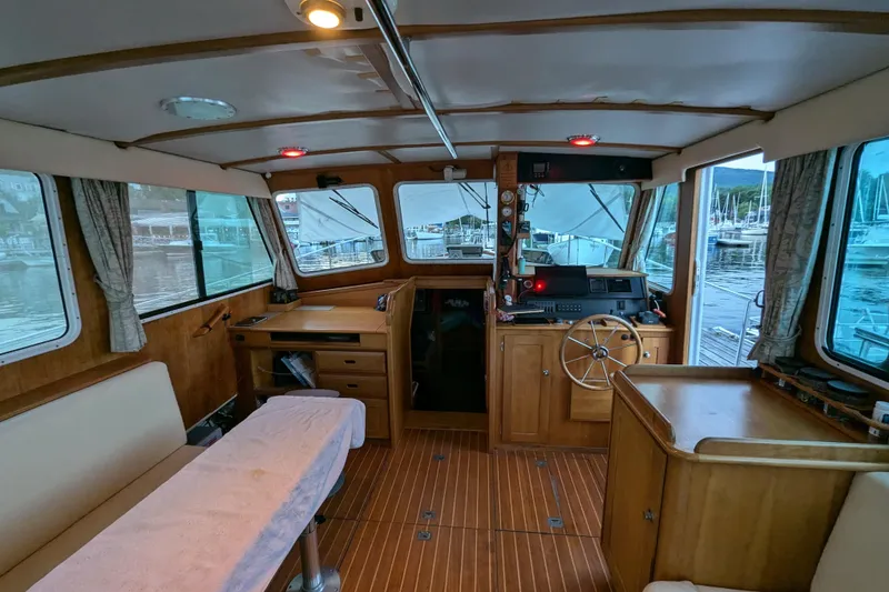 Slide: The Image of Interior of 2000 Duffy Flybridge 37 boat with wooden furnishings and helm station. - 9