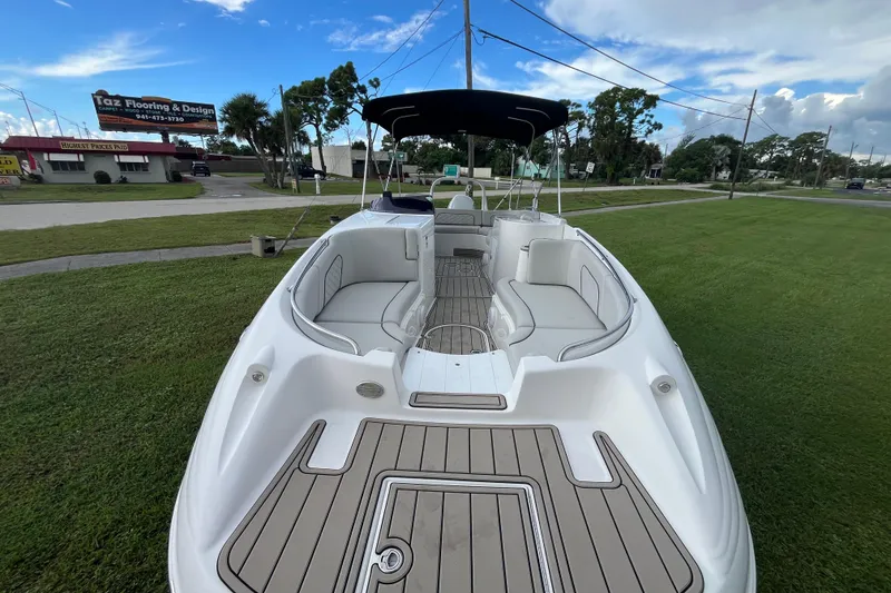 Slide: The Image of 2022 Citation 240 boat with spacious seating, displayed on grassy area under blue sky. - 14