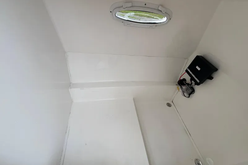 Slide: The Image of Interior of a 2022 Citation 240 boat, featuring a compact, white cabin space. - 16