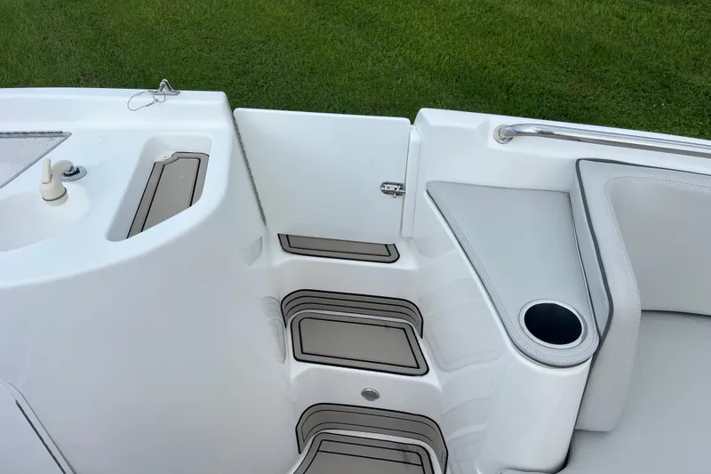 Slide: The Image of 2022 Citation 240 boat interior with steps and cup holder, featuring sleek white design. - 17