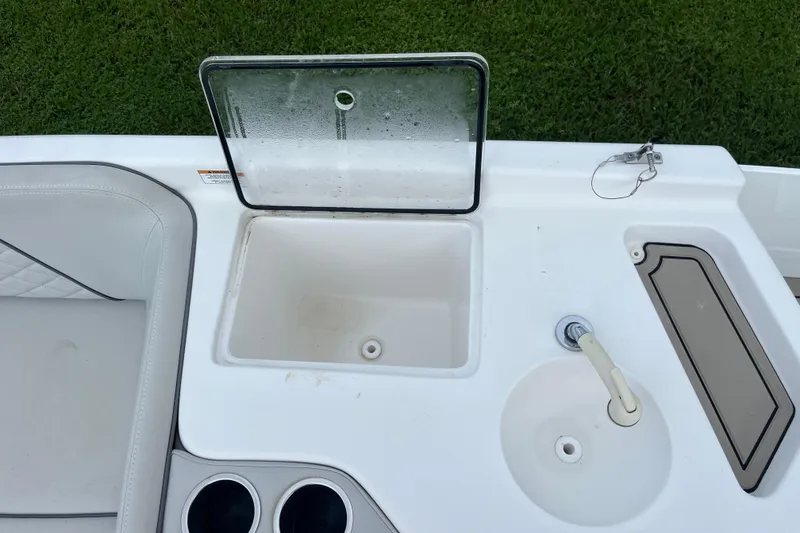 Slide: The Image of 2022 Citation 240 boat interior with open storage compartment and sink on deck. - 19