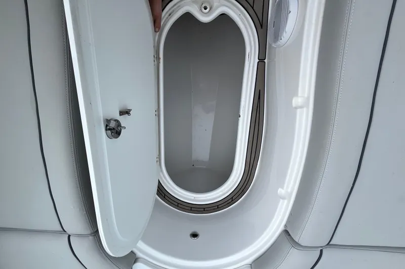 Slide: The Image of Open storage compartment on a 2022 Citation 240 boat, featuring sleek white interior design. - 21