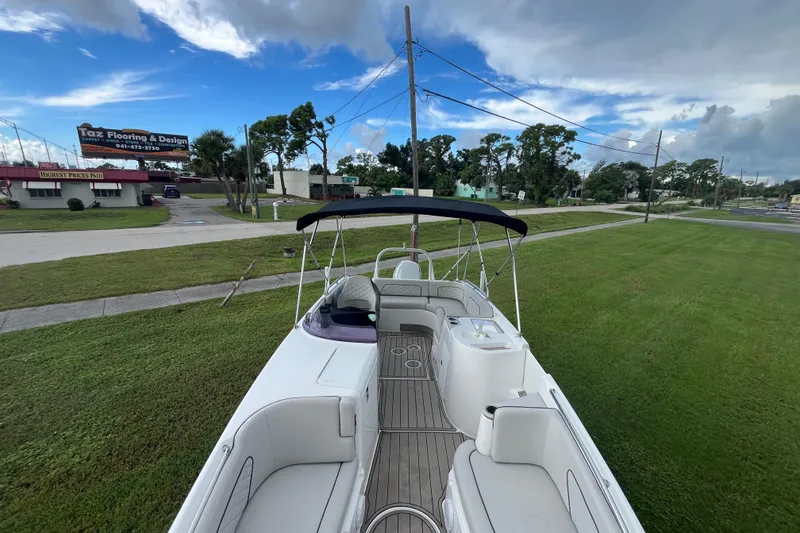 Slide: The Image of 2022 Citation 240 boat on grass, featuring spacious seating and canopy under a partly cloudy sky. - 22