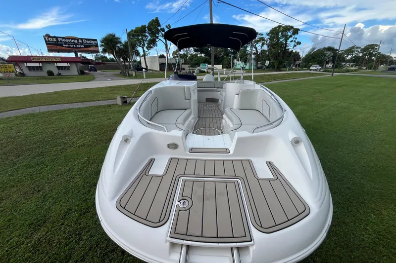 Slide: The Image of 2022 Citation 240 boat with spacious seating, docked on grassy area under blue sky. - 23
