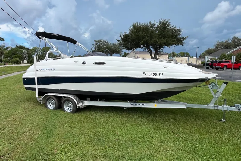 Slide: The Image of 2022 Citation 240 boat on trailer, parked on grass under cloudy sky. - 6