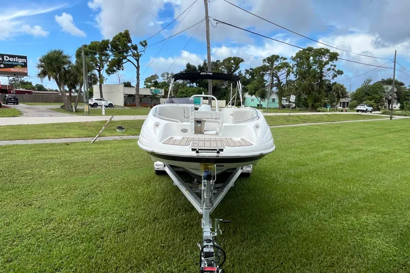 Slide: The Image of 2022 Citation 240 boat on trailer, parked on grassy area under cloudy sky. - 7