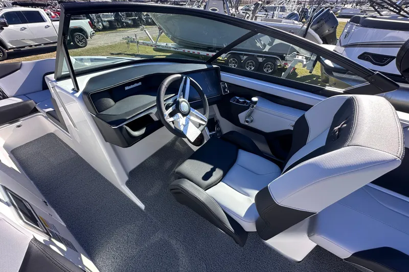 Slide: The Image of 2025 MasterCraft XT24 boat interior with modern steering and seating design. - 12