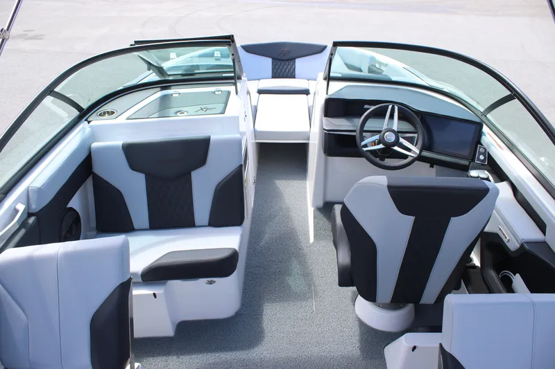 Slide: The Image of 2025 MasterCraft XT24 boat interior with modern seating and steering wheel design. - 18