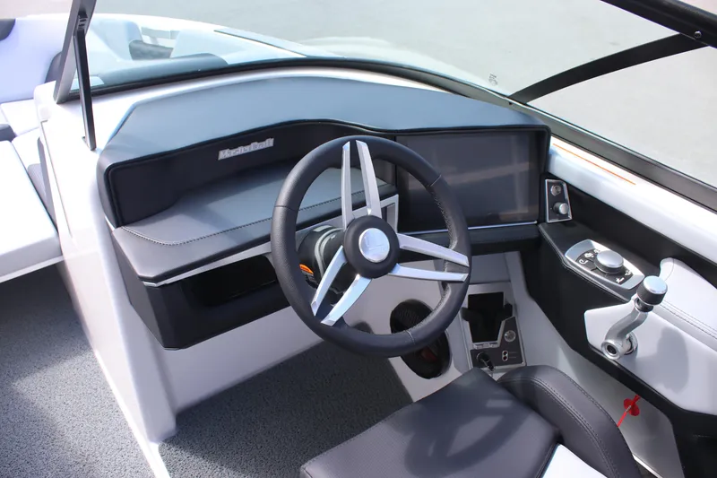 Slide: The Image of 2025 MasterCraft XT24 boat cockpit with modern steering wheel and control panel. - 6