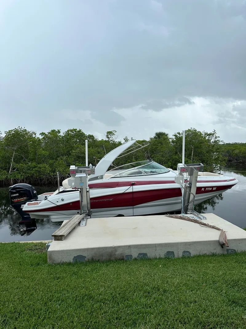 The Image of 2018 Crownline Eclipse E24 XS boat with red cover at dock. - 0