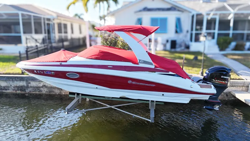 Slide: The Image of 2018 Crownline Eclipse E24 XS boat with red cover at dock. - 21