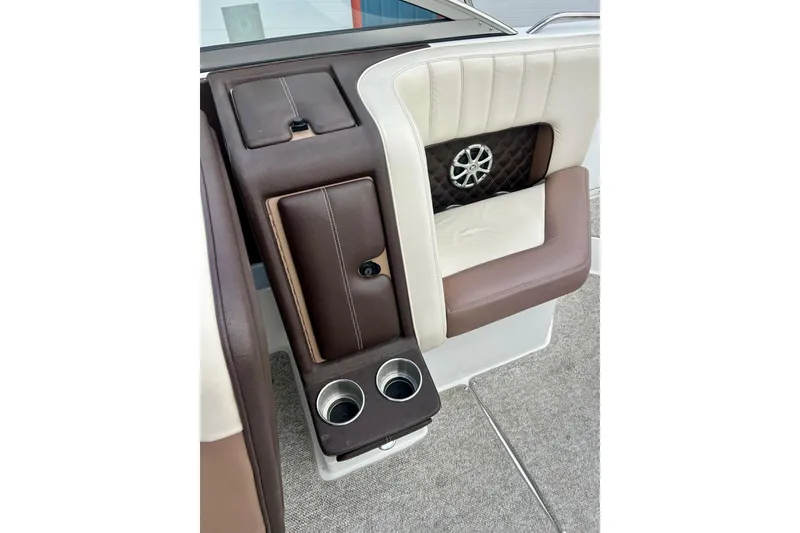 Slide: The Image of 2010 Cobalt 276 boat interior with brown and white seating, cup holders, and speaker. - 25