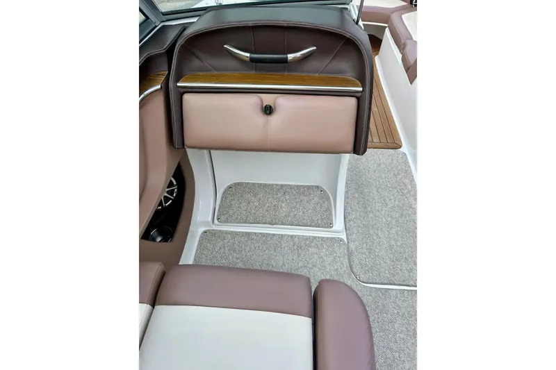 Slide: The Image of 2010 Cobalt 276 boat interior with brown leather seating and carpeted flooring. - 26